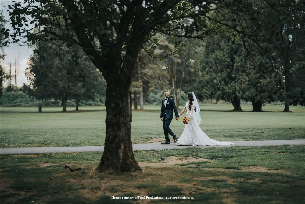 Bride-and-groom-walking-in-a-park-Pitt-Meadows-Golf-Club